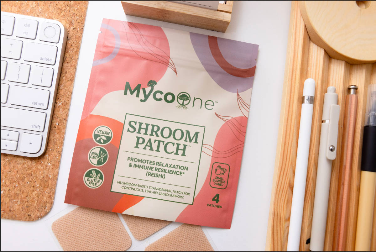 Mycone Shroom Patch packaging on a desk with stationery items